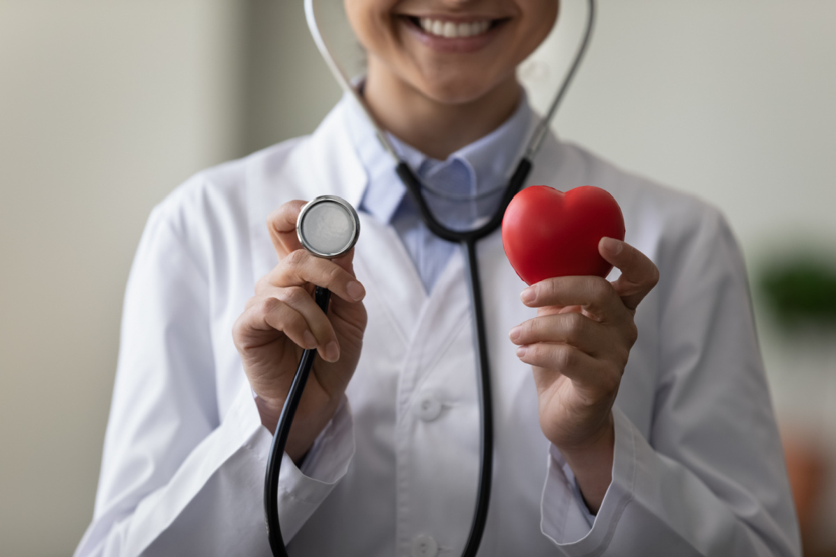 Medical Professional Holding Stethoscope and Heart